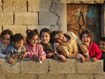 Palestinian Girls Giggle While Photographed Where Shell from an Israeli Gunboat Landed Earlier Stretched Canvas Print