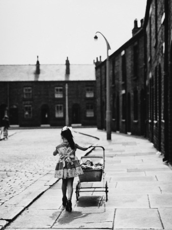 Little Girl Pushes Her Toy Pram Along a Street in Wigan Photographic Print Little Girl Pushes Her Toy Pram Along a Street in Wigan Photographic Print