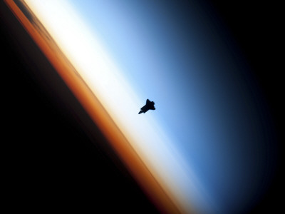 Silhouette of Space Shuttle Endeavour over Earth's Colorful Horizon Stretched Canvas Print