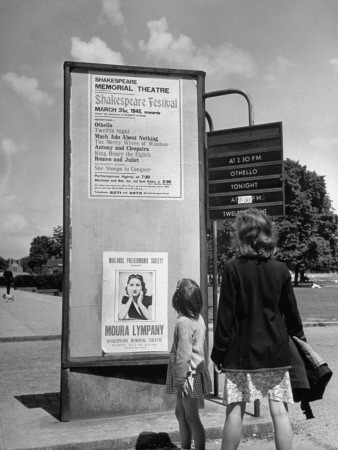 Two Young Visitors Looking at Notice Board Outside the Memorial Theatre Stretched Canvas Print