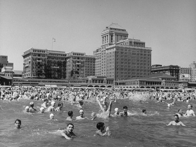 Swimmers Enjoying the Ocean Against a Backdrop of Hotels in Resort and Convention City Stretched Canvas Print