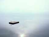 A Dock Appears to Hover in Mid-Air on the Placid Waters of Lake Thun