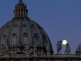 A Full Moon Rises over the Dome of St Peter's Basilica