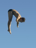 Profile shot of a young man diving