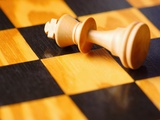 King chess piece lying on chessboard