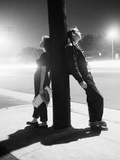 Teenagers Leaning on Utility Pole