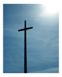 Cross against blue sky with sun
