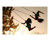 Girls Swinging at Sunset