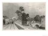 Train Pulls into the Station with Passengers Waiting on the Tracks