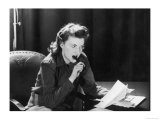 Woman Sits with Her Pen in Her Mouth Whilst Thinking About What She Should Write in Her Letter