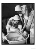 Two Nurses Bath a Baby
