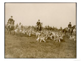 The Chase of the Devon and Somerset Stag Hunt with Horses and Hounds Running Downhill England