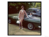 Girl in a Smart Summer Suit Poses Next to Her Boyfriend's MGB Sports Car