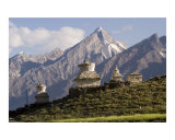 White Buddhist stupas with Snow Capped Zanskar range mountains