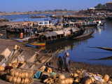 Fully Laden Pinasses Docked at the Jetty with More Cargo on the Shores of the Niger River  Mali