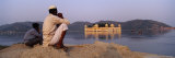 Two Men Sitting at a Lakeside with a Palace in the Background  Jal Mahal  Jaipur  Rajasthan  India