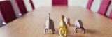 Four Dinosaur Toys on a Conference Table