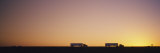 Silhouette of Two Trucks Moving on a Highway  Interstate 5  California  USA