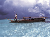Bajau Fisherman in Traditional Lepa Boat with Rain Clouds Behind  Pulau Gaya  Borneo  Malaysia