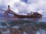 Bajau Fisherman on Lepa Boat in Shallow Water Over Coral Reef  Pulau Gaya  Borneo  Malaysia