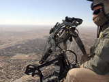 A Crew Chief Looks out for Suspicious Activity While Manning a Helicopters Machine Gun