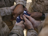 Marines Fold an American Flag after It was Raised in Memory of a Fallen Soldier