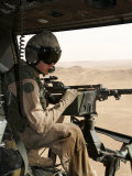 A UH-1N Huey Crew Chief Scans the Ground to Find a Target
