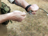 A Soldier Pulls a Detonation Cord Igniter to Start a Reaction Detonating C-4 Explosives