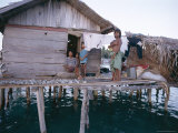 Bajau Family in Stilt House Over the Sea  with Fish Drying on Platform Outside  Sabah  Malaysia