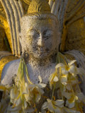 Close up of Small Buddha Figure with Flowers Round the Neck in the Shwedagon Paya  Yangon  Myanmar