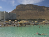 People Floating in the Sea and Hyatt Hotel and Desert Cliffs in Background  Dead Sea  Middle East