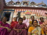 Group of Women Pilgrims Sitting on the Steps of Kedar Ghat with Temple in Background