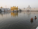 Two Sikh Pilgrims Bathing and Praying in the Early Morning in Holy Pool  Amritsar  India