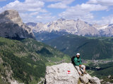 Hiker Resting at Alta Via Dolomiti Trail with Corvara Village Below  Dolomites  Alto Adige  Italy