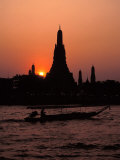 Silhouette of Wat Arun (Temple of the Dawn)  at Sunset  on Banks of Chao Phraya River  Thailand