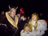 People Dressed up as the Devil and Two Angels in the Old Town on Eve of St Nicholas Day