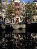 Tall Traditional Style Houses Reflected in the Water of a Canal  Amsterdam  the Netherlands