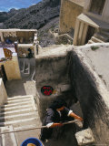 Greek Woman Baking Bread in Outdoors Communal Oven  Olymbos  Karpathos  Dodecanese Islands  Greece