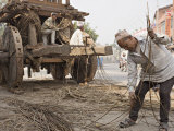 Man in Topi Hat Takes Part in the Annual Construction of a Chariot for a Religious Festival