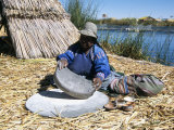 Uros (Urus) Woman Grinding Corn  Islas Flotantas  Reed Islands  Lake Titicaca  Peru  South America