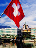 Swiss Flag on Mont Blanc Bridge with Quai General Guisan in Background  Geneva  Switzerland