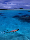 Snorkeller in the Clear Blue Waters off Aitutaki in the South Pacific  Cook Islands
