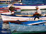 Fishermen Mending Nets in Boats on Costa del Azahar  Peniscola  Valencia  Spain