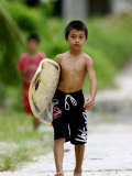 Young Local Boy Heading Out for Afternoon Surf  Lagundri Bay  Pulau Nias  North Sumatra  Indonesia