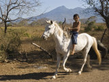 Boy Riding White Horse Bareback with Volcan Mombacho in Background  Granada  Nicaragua