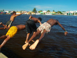 Young Boys Dive Off Marina at Bay of Belize with City in Background  Belize City  Belize