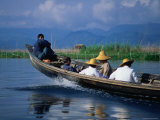 Passengers Riding High in a Traditional Boat on Lake Inle  Myanmar