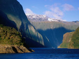 Boat in Distance Between Mountains  Milford Sound  New Zealand