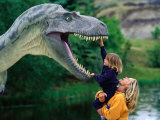 Woman Holding a Girl Up to a Dinosaur Model  Drumheller Valley  Alberta  Canada