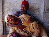 Man Holding Other Man Sick with Malaria  Ethiopia